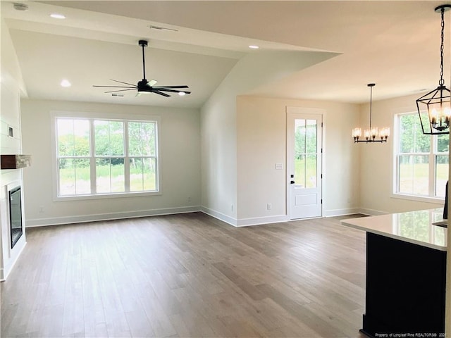 285 Delmore Rd, Autryville, NC 28318 - unfurnished living room featuring a chandelier, wood finished floors, baseboards, ceiling fan, and recessed lighting