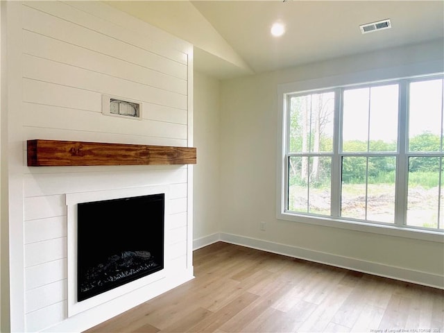 285 Delmore Rd, Autryville, NC 28318 - unfurnished living room featuring wood finished floors, lofted ceiling, a large fireplace, baseboards, and recessed lighting