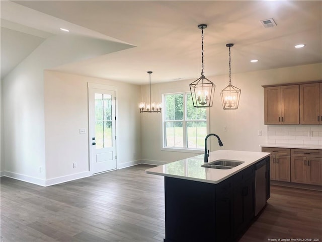 285 Delmore Rd, Autryville, NC 28318 - kitchen featuring a sink, a chandelier, light countertops, dark wood-type flooring, and baseboards