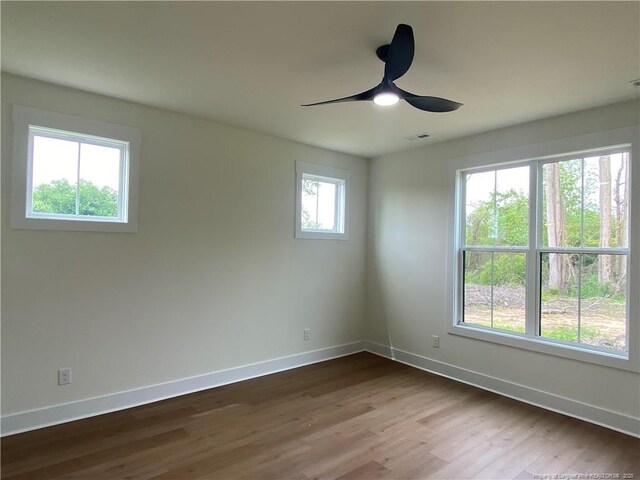 285 Delmore Rd, Autryville, NC 28318 - empty room featuring baseboards, dark wood-style flooring, and a ceiling fan