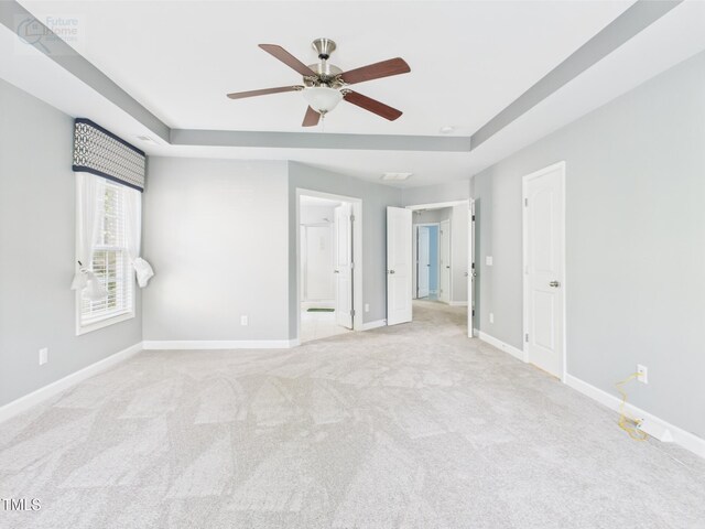 1728 Callandale Ave, Cary, NC 27518 - unfurnished bedroom featuring a raised ceiling, light colored carpet, baseboards, and ensuite bath