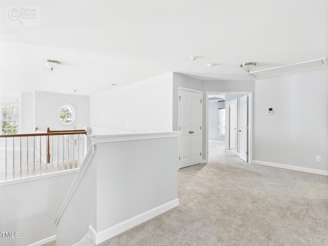 1728 Callandale Ave, Cary, NC 27518 - hall with an upstairs landing, light colored carpet, attic access, and baseboards