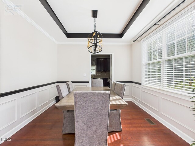 1728 Callandale Ave, Cary, NC 27518 - dining room with a tray ceiling, a decorative wall, dark wood-style floors, a chandelier, and wainscoting