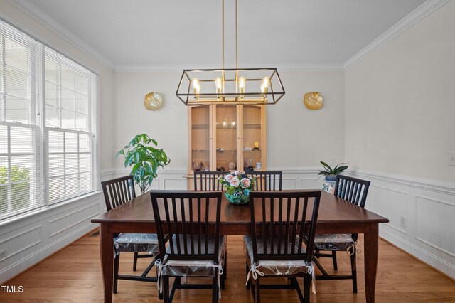 100 Maywood Way, Chapel Hill, NC 27516 - dining space with healthy amount of natural light, a chandelier, ornamental molding, a wainscoted wall, and a decorative wall