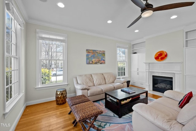 100 Maywood Way, Chapel Hill, NC 27516 - living room featuring healthy amount of natural light, baseboards, light wood-style floors, ceiling fan, and ornamental molding