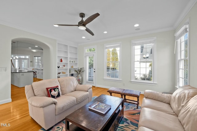 100 Maywood Way, Chapel Hill, NC 27516 - living room featuring ornamental molding, light wood finished floors, recessed lighting, ceiling fan, and arched walkways