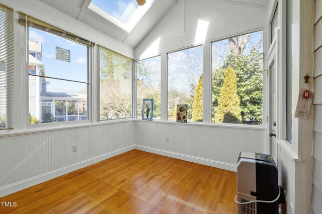 100 Maywood Way, Chapel Hill, NC 27516 - unfurnished sunroom with wood finished floors, a skylight, heating unit, healthy amount of natural light, and lofted ceiling
