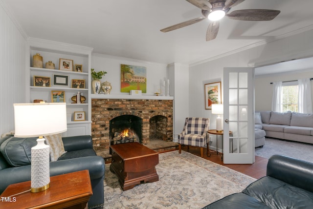 1115 Laurel Ln NW, Wilson, NC 27896 - living room featuring ornamental molding, wood finished floors, a ceiling fan, and a fireplace