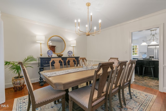 1115 Laurel Ln NW, Wilson, NC 27896 - dining space featuring crown molding, a chandelier, and wood finished floors