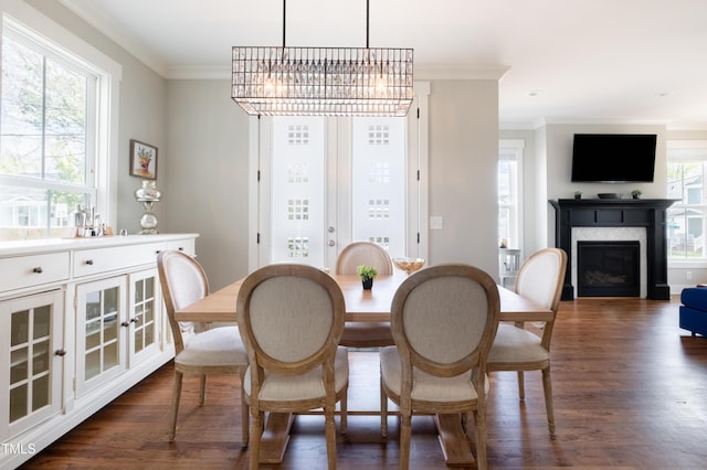 595 E Cabarrus St, Raleigh, NC 27601 - dining space with ornamental molding, dark wood finished floors, a fireplace, and a chandelier