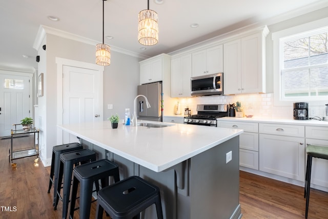 595 E Cabarrus St, Raleigh, NC 27601 - kitchen featuring stainless steel appliances, a sink, an island with sink, white cabinets, and backsplash