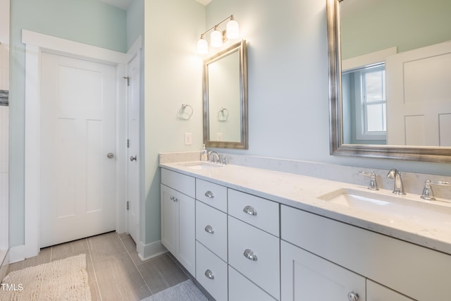 595 E Cabarrus St, Raleigh, NC 27601 - bathroom with double vanity and baseboards