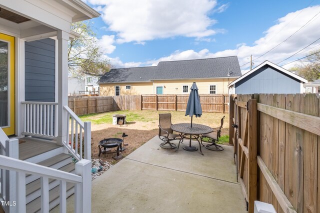 595 E Cabarrus St, Raleigh, NC 27601 - fenced backyard featuring an outdoor fire pit and a patio
