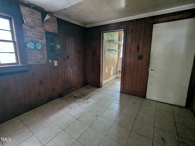 207 Bruton St W, Wilson, NC 27893 - empty room featuring wooden walls, ornamental molding, and light tile patterned floors
