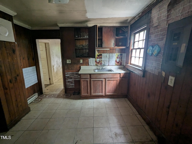 207 Bruton St W, Wilson, NC 27893 - kitchen with wood walls, a sink, light countertops, open shelves, and a baseboard heating unit