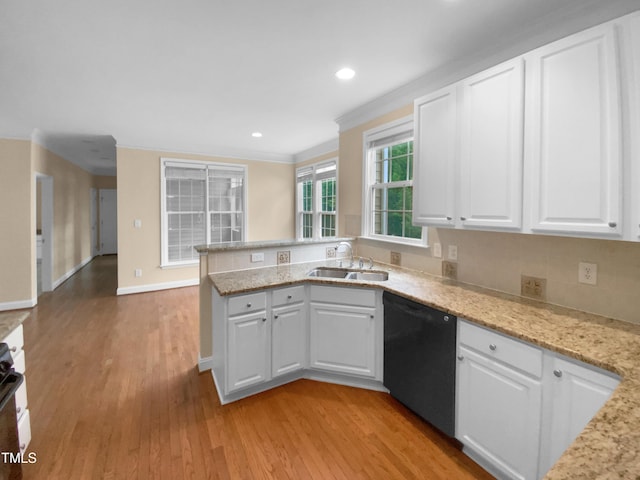 3116 Kirby St, Durham, NC 27713 - kitchen with black dishwasher, a sink, light wood-style flooring, white cabinetry, and crown molding