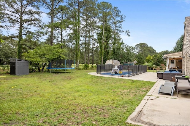 2409 Cypress Lakes Rd, Hope Mills, NC 28348 - view of yard with a trampoline, an outdoor living space, a pool, and a patio