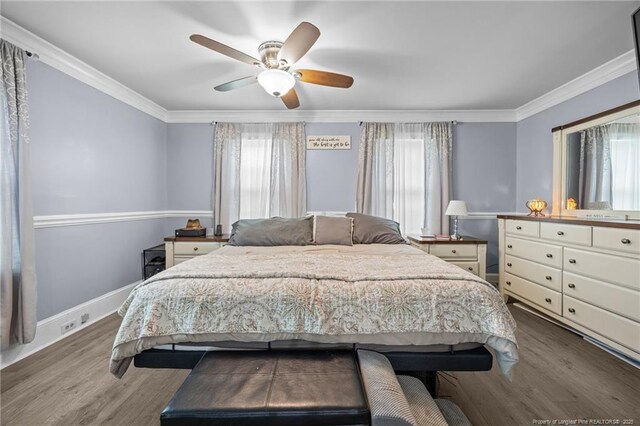 2409 Cypress Lakes Rd, Hope Mills, NC 28348 - bedroom featuring multiple windows, ornamental molding, wood finished floors, and baseboards