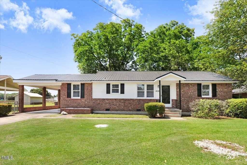 406 Cardinal Dr, Goldsboro, NC 27534 - ranch-style home with driveway, an attached carport, brick siding, and a front lawn