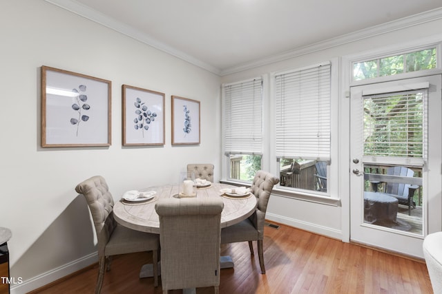 222 Ashton Hall Ln, Raleigh, NC 27609 - dining room featuring ornamental molding, light wood-style floors, and baseboards