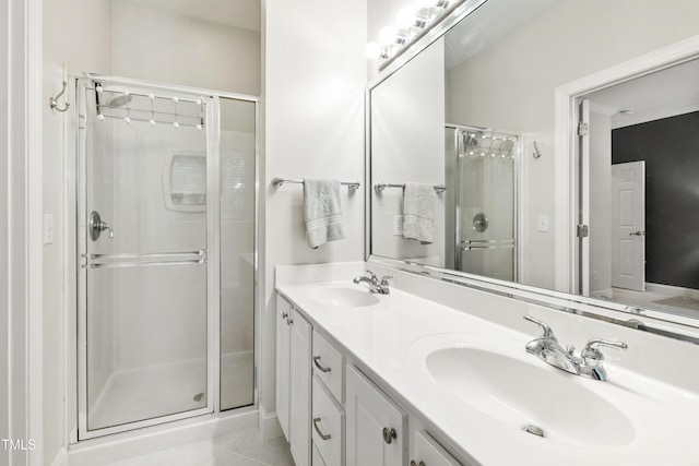 222 Ashton Hall Ln, Raleigh, NC 27609 - bathroom with a shower stall, double vanity, and tile patterned floors