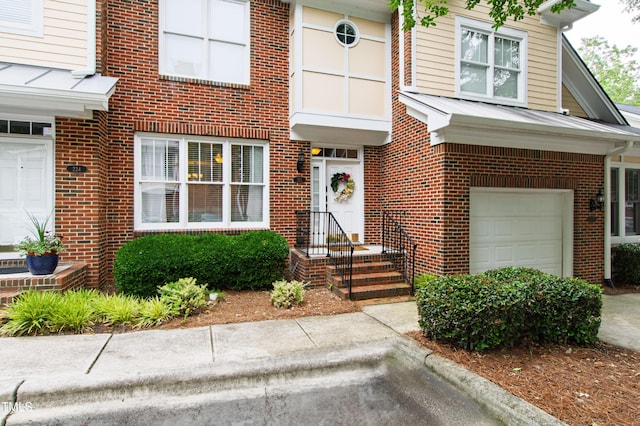 222 Ashton Hall Ln, Raleigh, NC 27609 - view of front of house featuring an attached garage and brick siding