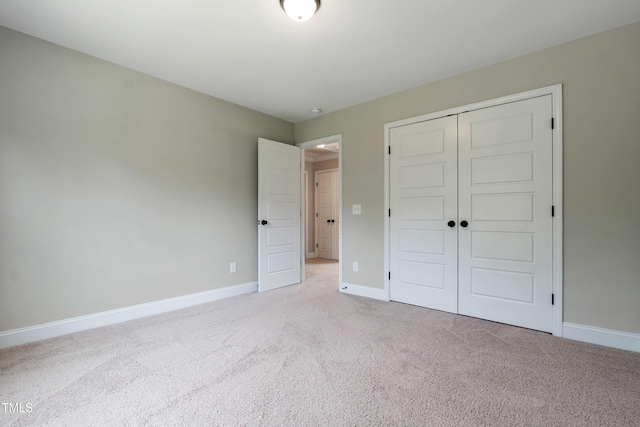 550 Spring Flowers Dr, Cameron, NC 28326 - unfurnished bedroom featuring light carpet, a closet, and baseboards