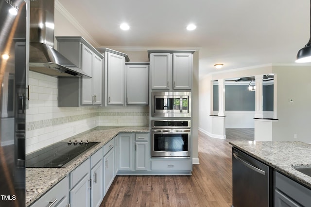 550 Spring Flowers Dr, Cameron, NC 28326 - kitchen featuring stainless steel appliances, wall chimney exhaust hood, backsplash, gray cabinetry, and ornamental molding