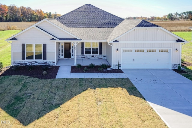 61 Merrifield Ln, Garner, NC 27529 - ranch-style house with board and batten siding, an attached garage, driveway, a porch, and roof with shingles