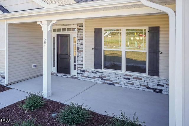 61 Merrifield Ln, Garner, NC 27529 - doorway to property featuring covered porch and stone siding