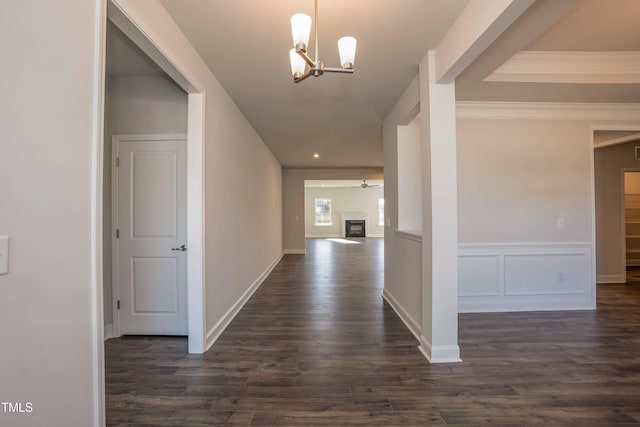 61 Merrifield Ln, Garner, NC 27529 - hall featuring dark wood-type flooring, a chandelier, wainscoting, and ornamental molding