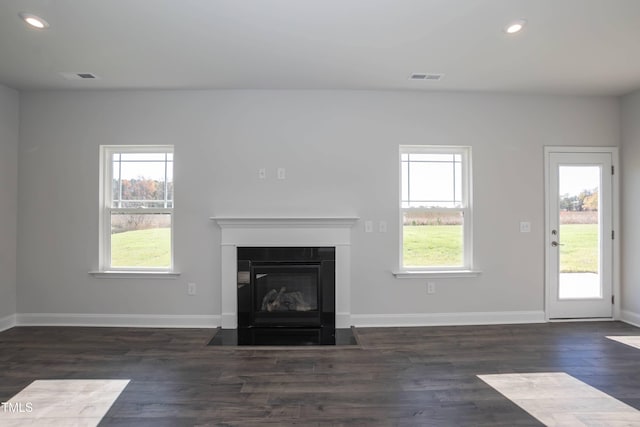 61 Merrifield Ln, Garner, NC 27529 - unfurnished living room with wood finished floors, recessed lighting, a fireplace with flush hearth, and baseboards