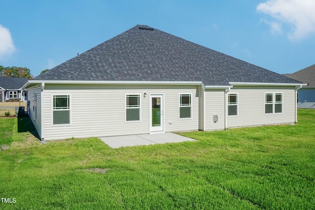 61 Merrifield Ln, Garner, NC 27529 - back of house featuring a shingled roof, a patio, and a lawn