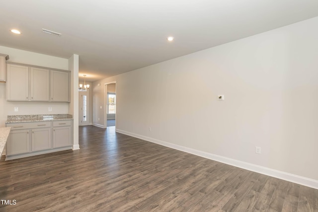 61 Merrifield Ln, Garner, NC 27529 - unfurnished living room featuring dark wood-style flooring, a chandelier, baseboards, and recessed lighting