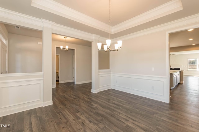 61 Merrifield Ln, Garner, NC 27529 - unfurnished dining area featuring a chandelier, a raised ceiling, dark wood-style floors, a wainscoted wall, and recessed lighting