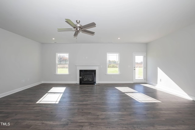 61 Merrifield Ln, Garner, NC 27529 - unfurnished living room featuring a fireplace with flush hearth, recessed lighting, baseboards, a ceiling fan, and dark wood-style flooring