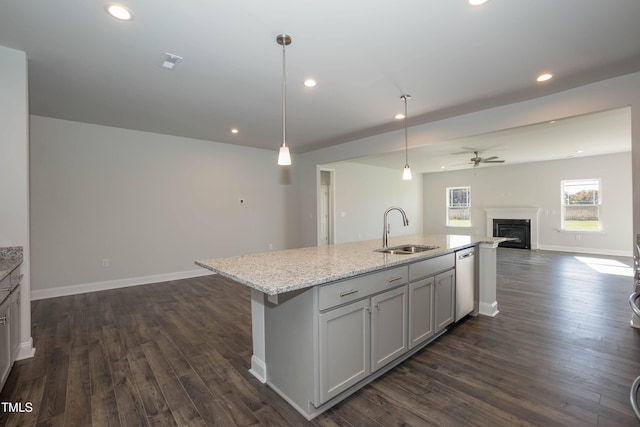 61 Merrifield Ln, Garner, NC 27529 - kitchen featuring open floor plan, a sink, dishwasher, ceiling fan, and a glass covered fireplace