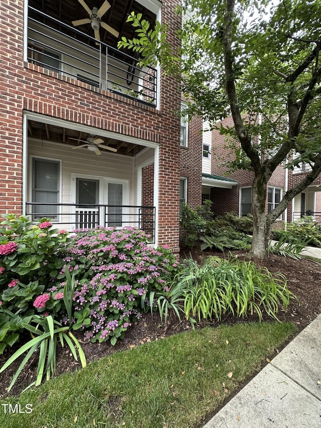 710 N Person St Unit 103, Raleigh, NC 27604 - view of home's exterior with a balcony, ceiling fan, and brick siding