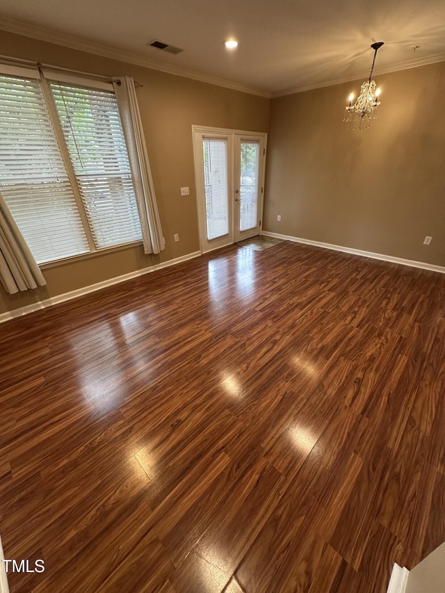 710 N Person St Unit 103, Raleigh, NC 27604 - unfurnished room featuring a chandelier, dark wood-style floors, plenty of natural light, baseboards, and crown molding