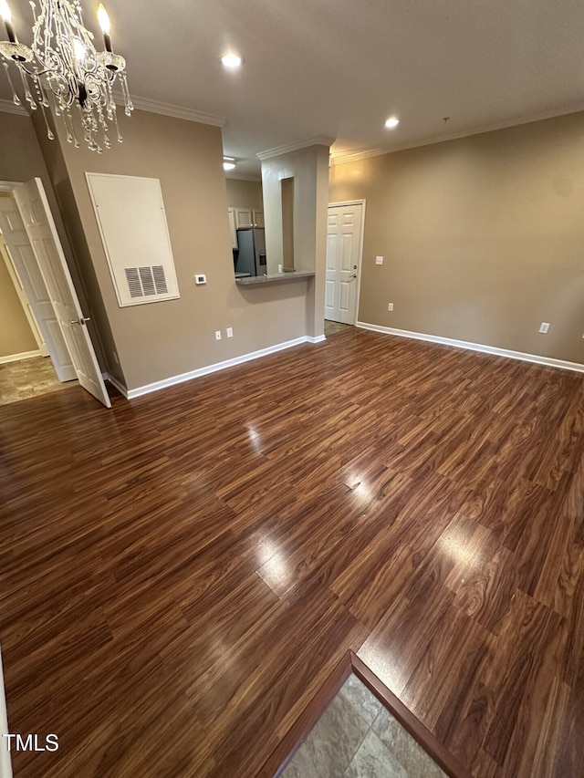 710 N Person St Unit 103, Raleigh, NC 27604 - unfurnished living room with ornamental molding, baseboards, a chandelier, dark wood-style floors, and recessed lighting