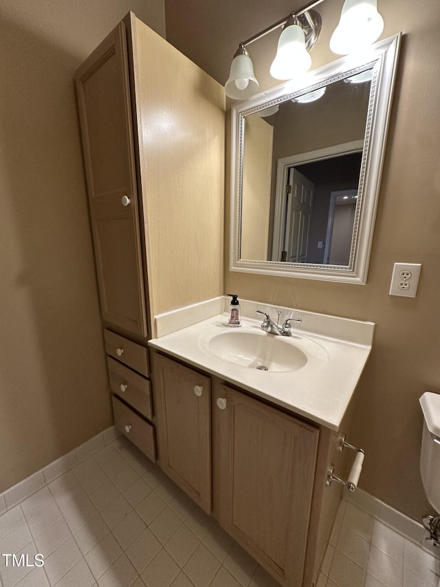 710 N Person St Unit 103, Raleigh, NC 27604 - half bathroom with tile patterned flooring, vanity, baseboards, and toilet