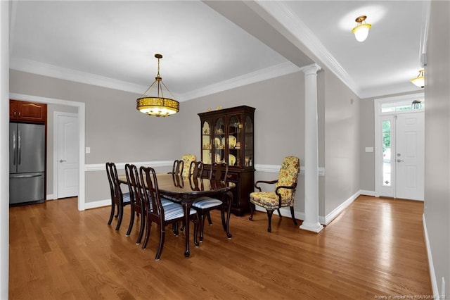 3207 Notting Hill Rd, Fayetteville, NC 28311 - dining room featuring ornate columns, wood finished floors, ornamental molding, and baseboards