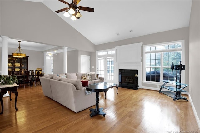 3207 Notting Hill Rd, Fayetteville, NC 28311 - living room featuring decorative columns, a fireplace with flush hearth, light wood-type flooring, ceiling fan, and high vaulted ceiling
