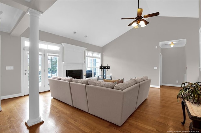 3207 Notting Hill Rd, Fayetteville, NC 28311 - living area featuring decorative columns, high vaulted ceiling, a fireplace, a ceiling fan, and wood finished floors