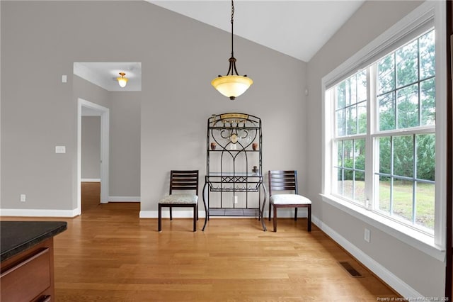 3207 Notting Hill Rd, Fayetteville, NC 28311 - living area with vaulted ceiling, light wood-style flooring, and baseboards