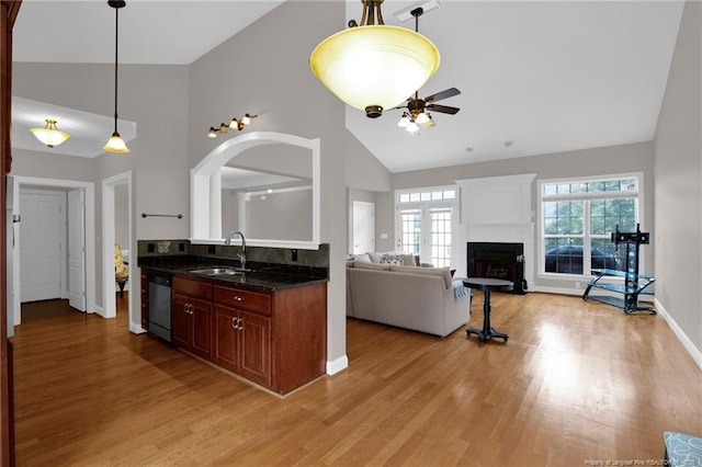 3207 Notting Hill Rd, Fayetteville, NC 28311 - kitchen featuring a sink, a fireplace, high vaulted ceiling, light wood-type flooring, and a ceiling fan