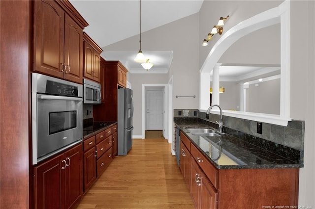 3207 Notting Hill Rd, Fayetteville, NC 28311 - kitchen featuring stainless steel appliances, a sink, light wood-type flooring, tasteful backsplash, and arched walkways
