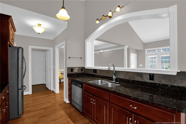 3207 Notting Hill Rd, Fayetteville, NC 28311 - kitchen featuring appliances with stainless steel finishes, a sink, tasteful backsplash, reddish brown cabinets, and light wood finished floors