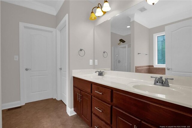 3207 Notting Hill Rd, Fayetteville, NC 28311 - bathroom featuring a shower stall, double vanity, baseboards, tile patterned flooring, and ornamental molding
