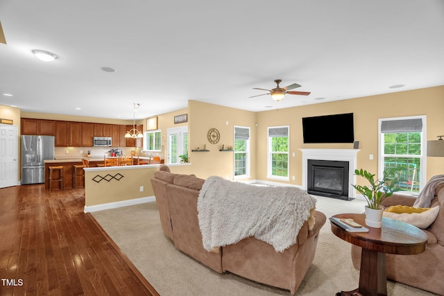 1428 White Opal Dr, Knightdale, NC 27545 - living area featuring dark wood-style floors, a fireplace with flush hearth, a ceiling fan, and recessed lighting